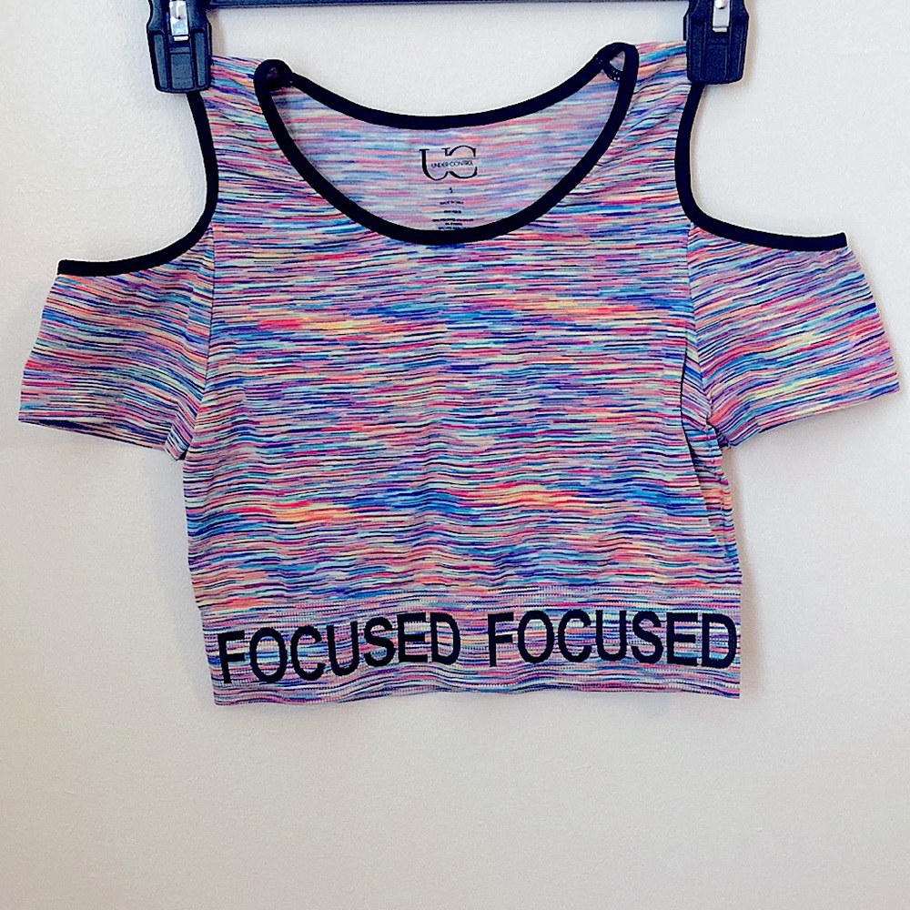 Activewear crop top, cut outs on shoulder. Colorful and words FOCUSED on bottom